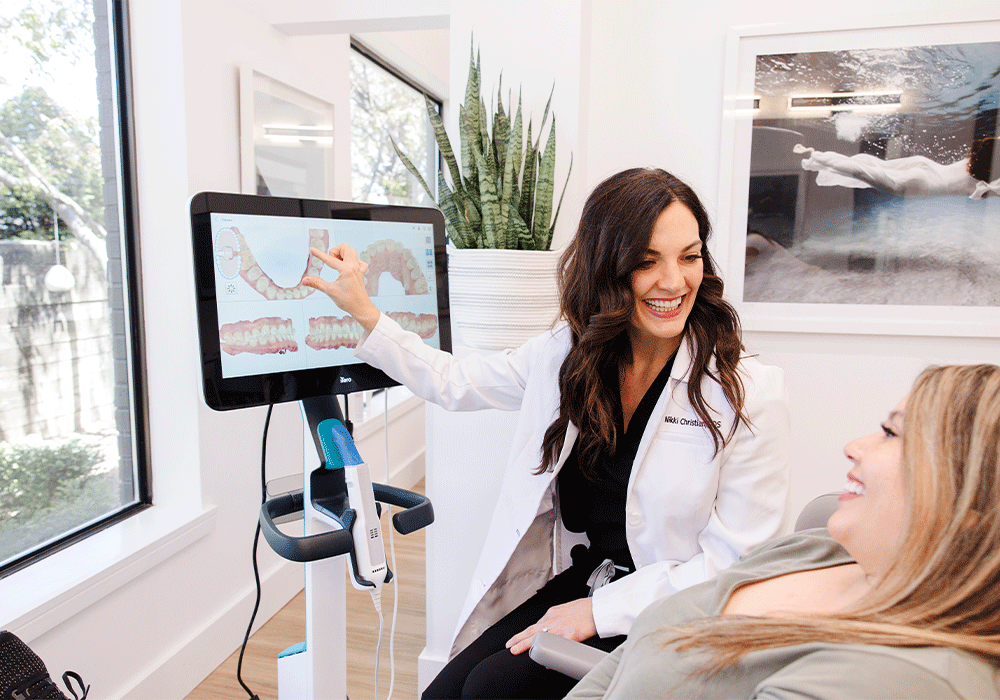 Dr. Nikki showing a patient the digital scan of her teeth.